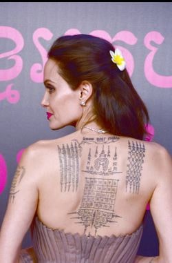 A picture of Tattoos on the back of Angelina Jolie.